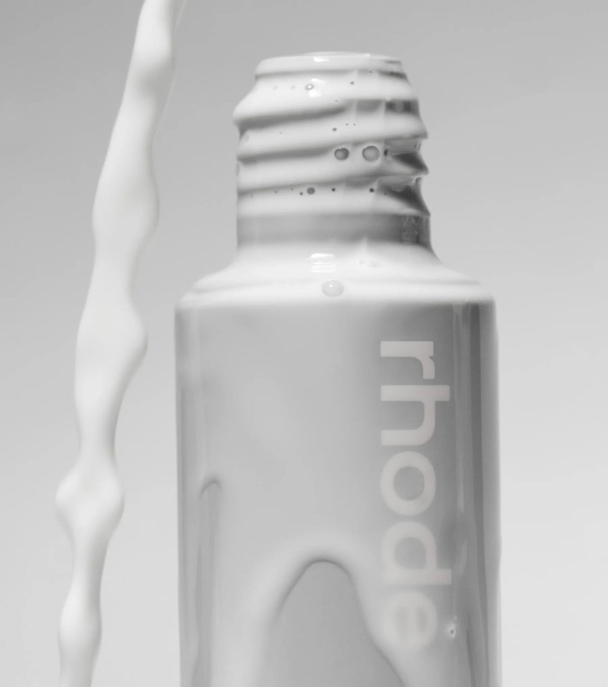 Rhode Glazing Milk close-up product shot with milk splash
