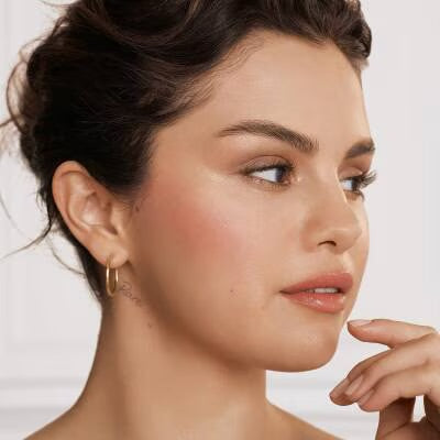 Model wearing Rare Beauty Soft Pinch Liquid Blush
