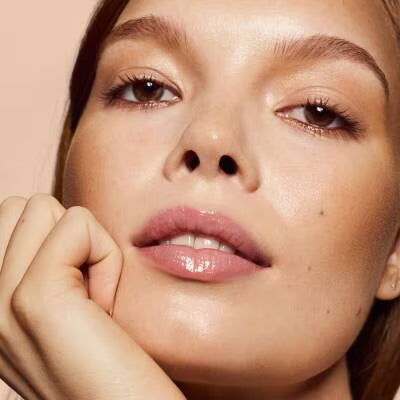 Model wearing Fenty Beauty Gloss Bomb Heat in Glass Slipper