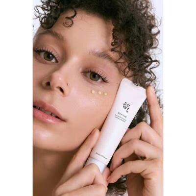 Beauty of Joseon Revive Eye Serum model holding tube to face