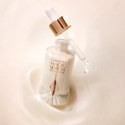 Charlotte's Magic Serum Crystal Elixir bottle in liquid splash